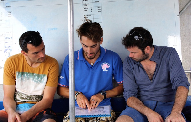 Last men standing: Michael (middle) briefs Johnny and Peter before their second open water dive