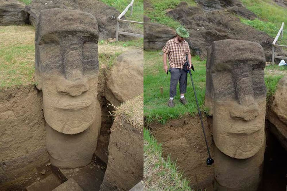 Two statues with the earth below dug up and a man stood beside showing their true height