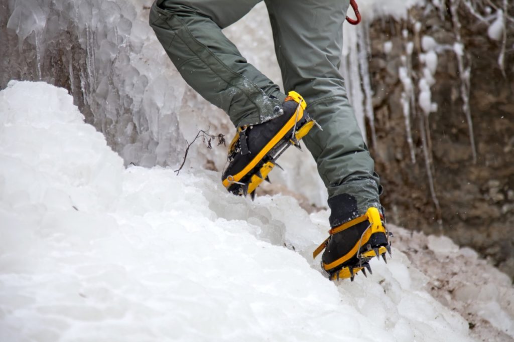 Man with crampons while winter hiking