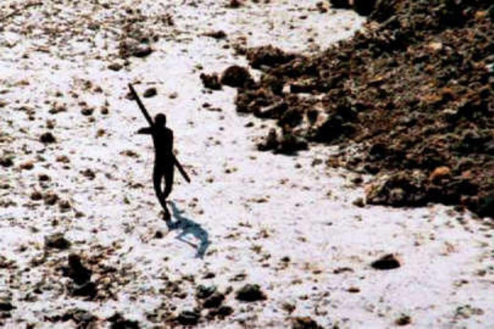 A lone tribesman takes aim at an Indian Coast Guard helicopter