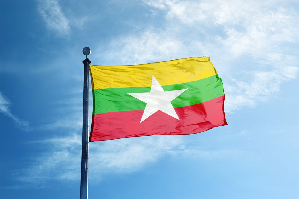 Myanmar's flag flying against a blue sky