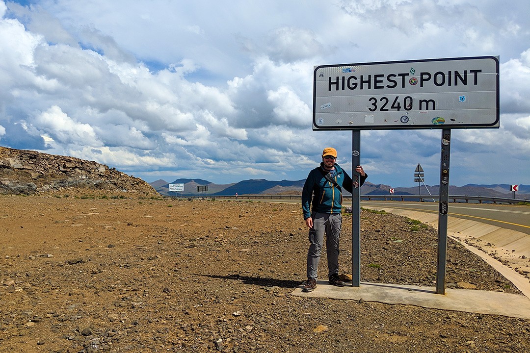 Peter stood next to a sign saying highest point 3240m
