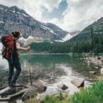 female hiker beside a lake