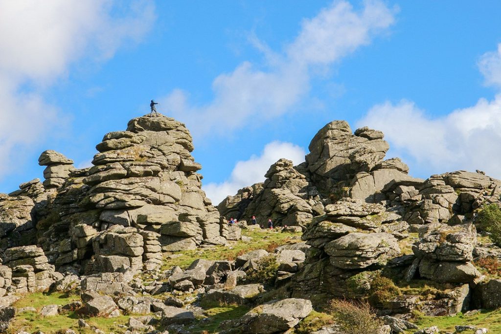 Rock climbers on Hound Tor one of the best hikes in Dartmoor National Park