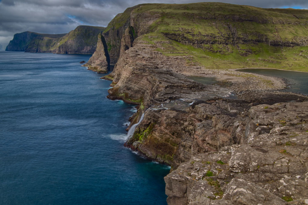 Bøsdalafossur waterfall feeds into the ocean