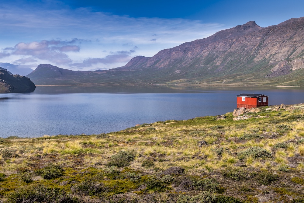 trekking the arctic circle trail lead image with hut and lake