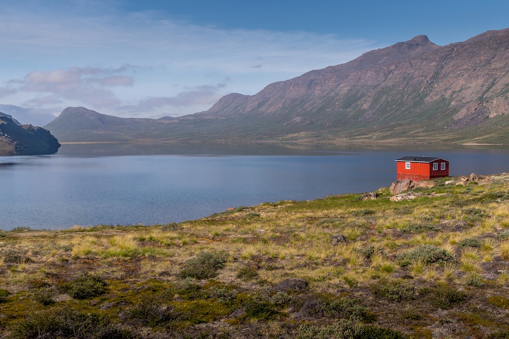 trekking the arctic circle trail lead image with hut and lake