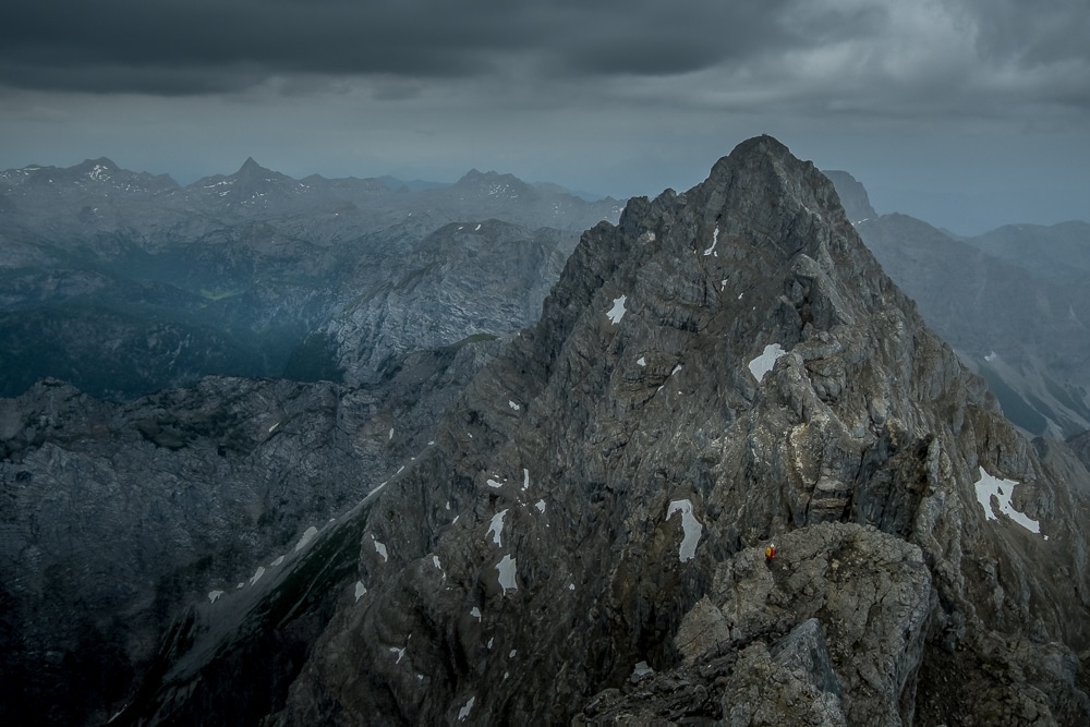 A hiker descends the Mittelspitze en route to the Südspitze