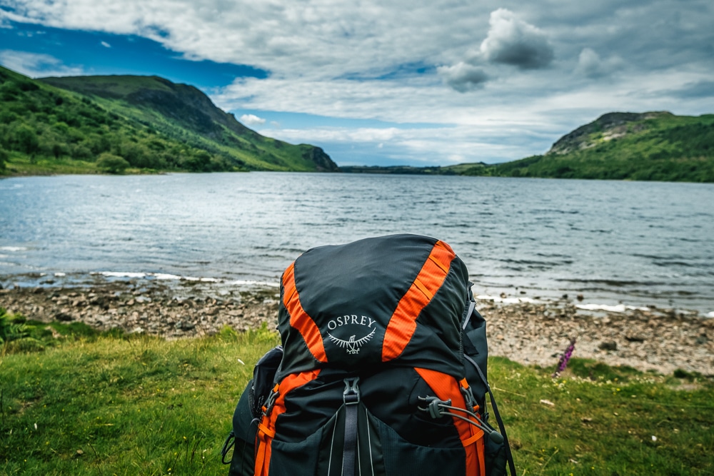 A backpack in front of a lake on the Coast to Coast