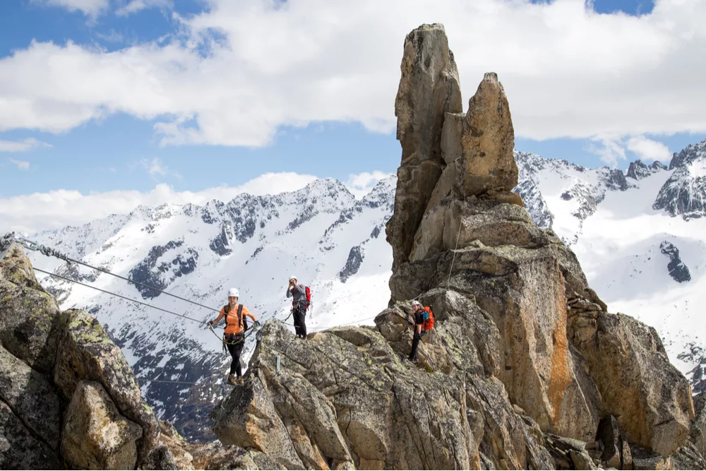 Tourists completing a via ferrata in Switzerland, one of the best countries for adventure travel