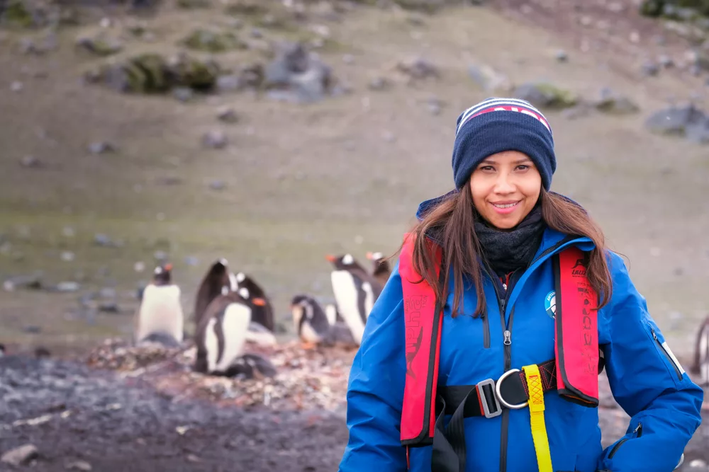 Kia in Antarctica with penguins