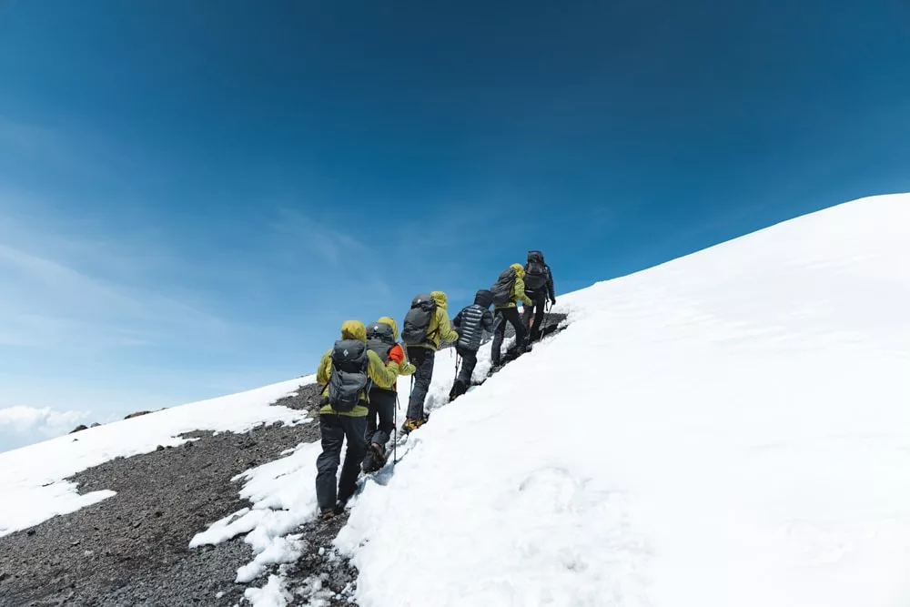 Trekkers approach the summit through snow on Kilimanjaro