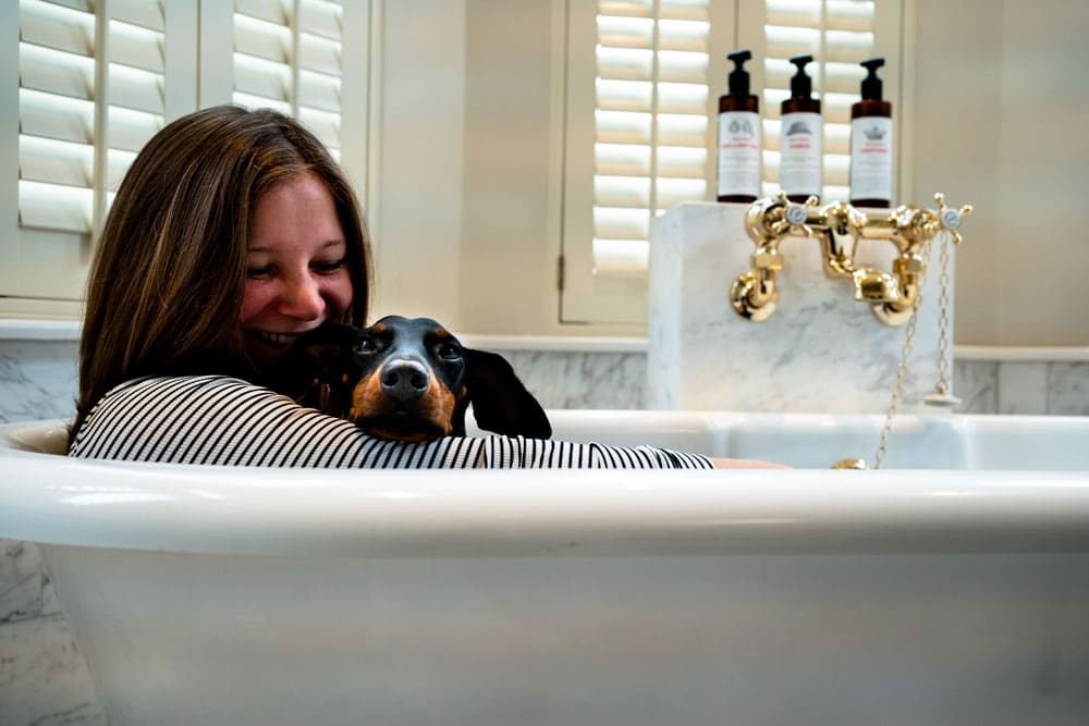 Lottie and her dog in the bath