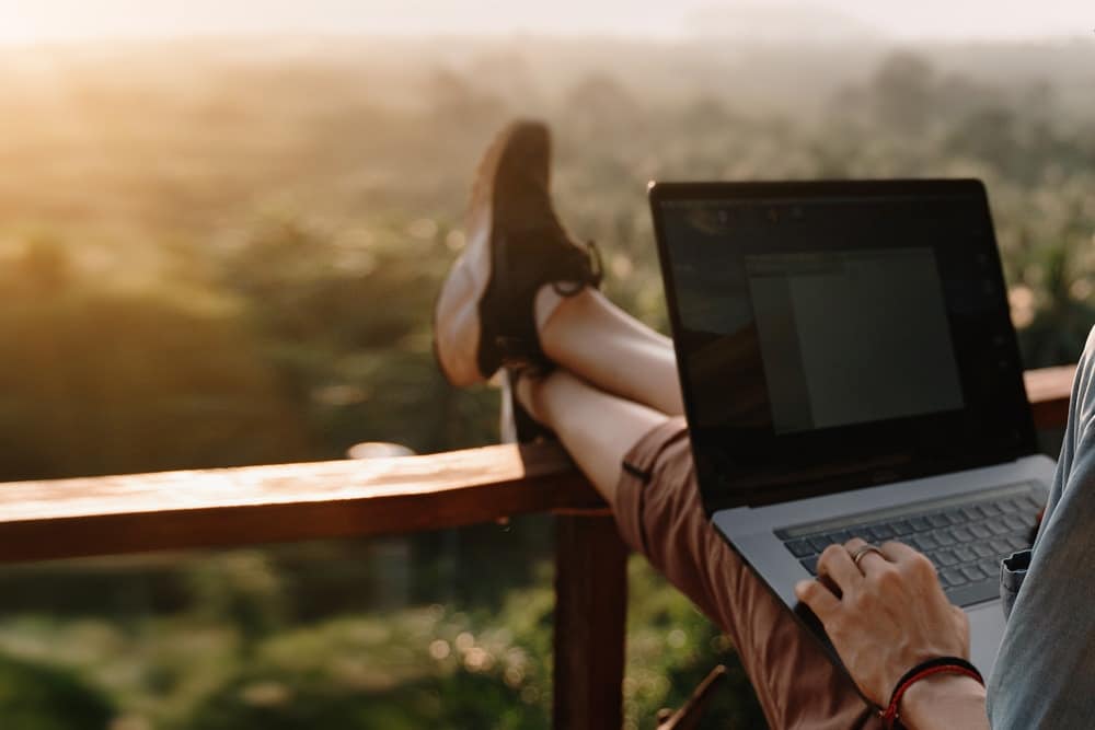 woman using laptop in one of the countries offering remote work visas