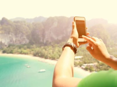 Traveller taking a photo on her smartphone