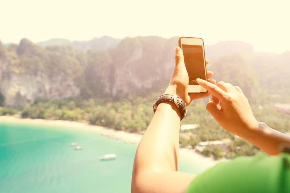 Traveller taking a photo on her smartphone