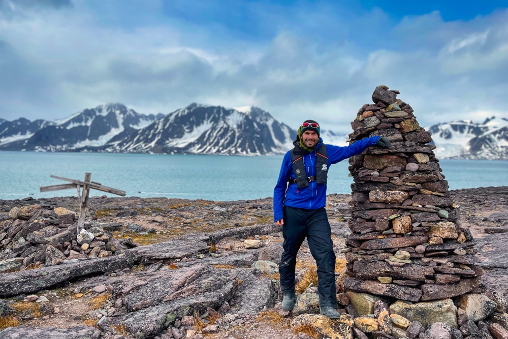 Peter by a cairn on Alicehamna  – one of the reasons to visit Svalbard