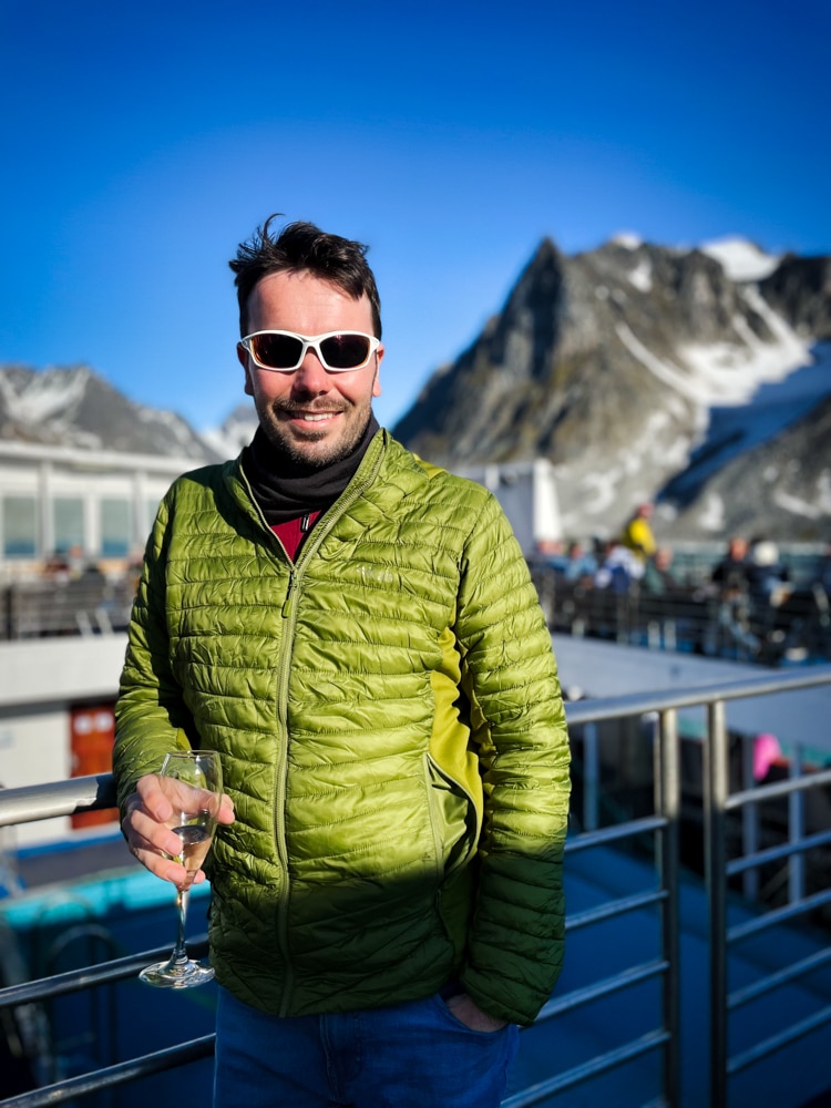 Peter drinking champaign  – one of the reasons to visit Svalbard
