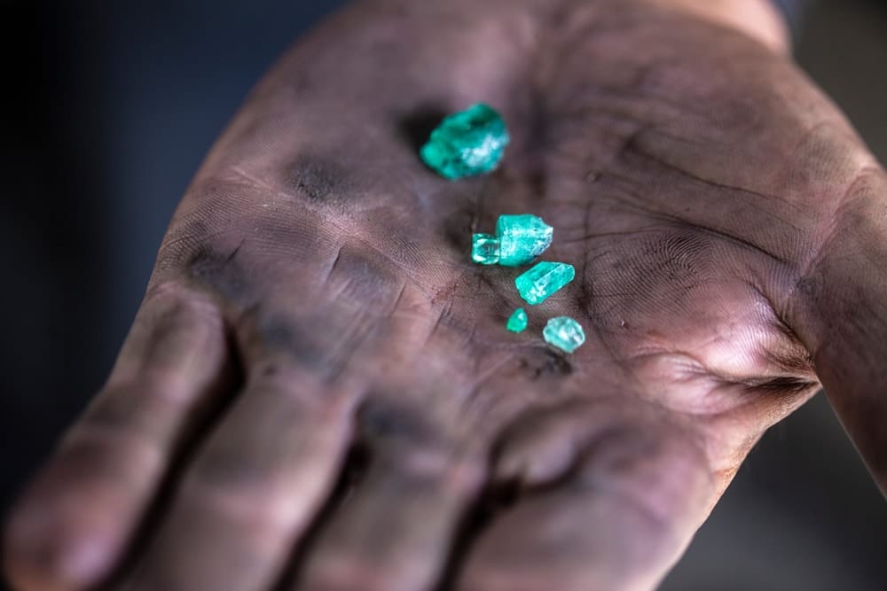 Colombian emerald in a miner's hand