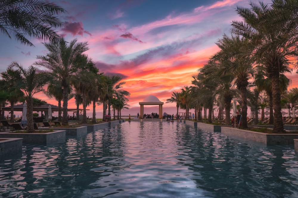 Sunset over a pool at the Hilton Ras Al Khaimah Beach Resort