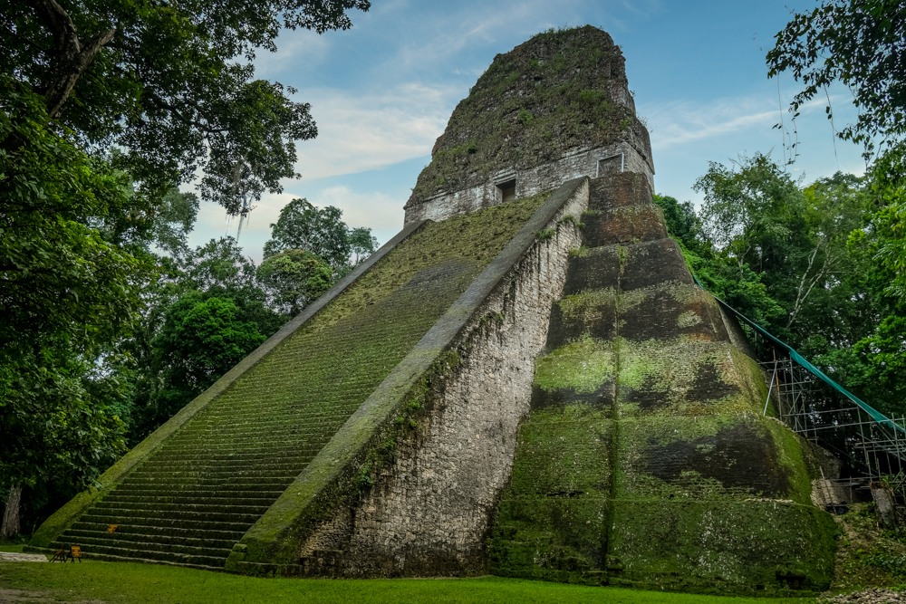 Temple V in Tikal covered in moss