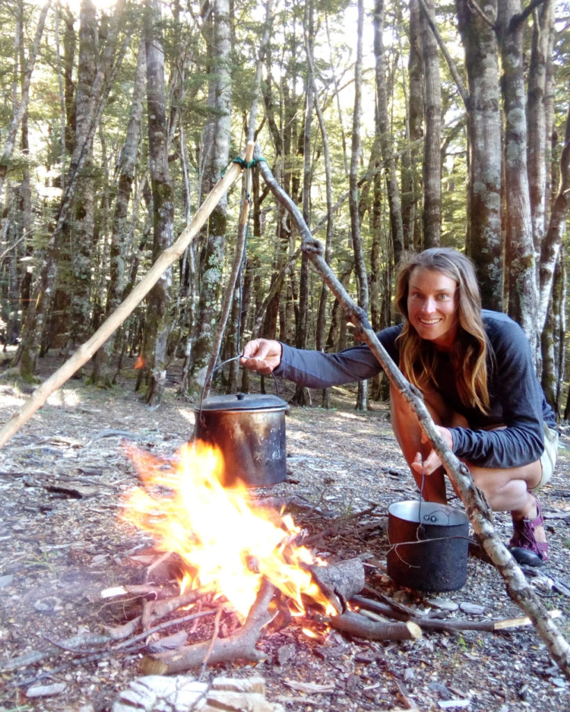 Miriam cooking in a forest