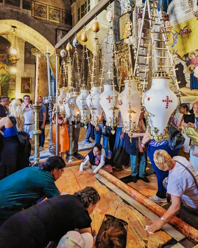 Pilgrims touch the Stone of Unction 