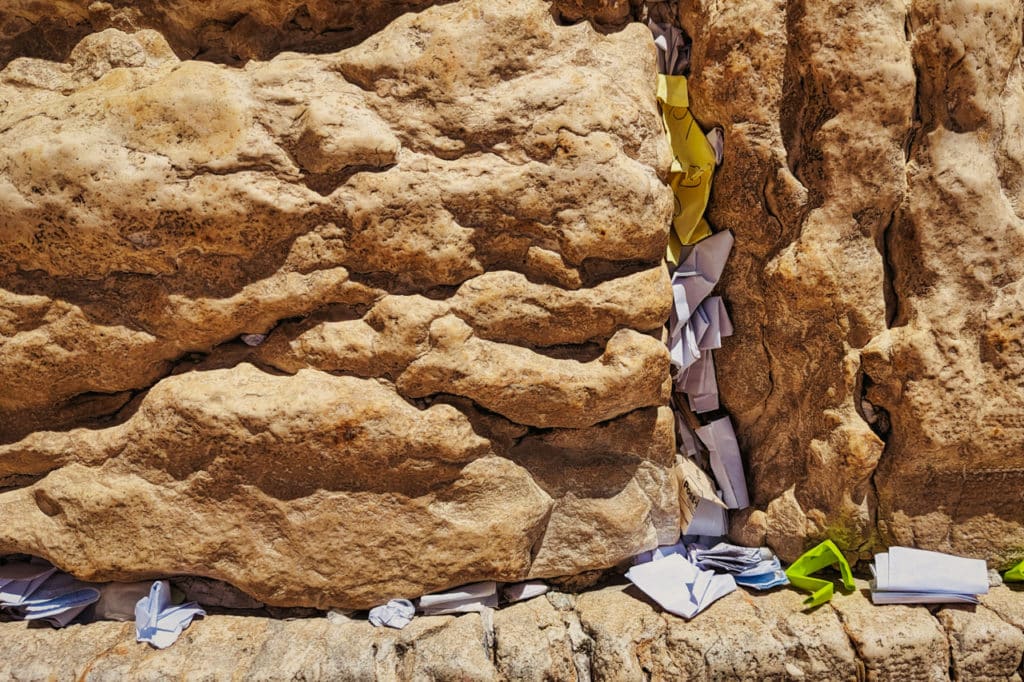 A close up of the wall showing the prayers on slips of paper