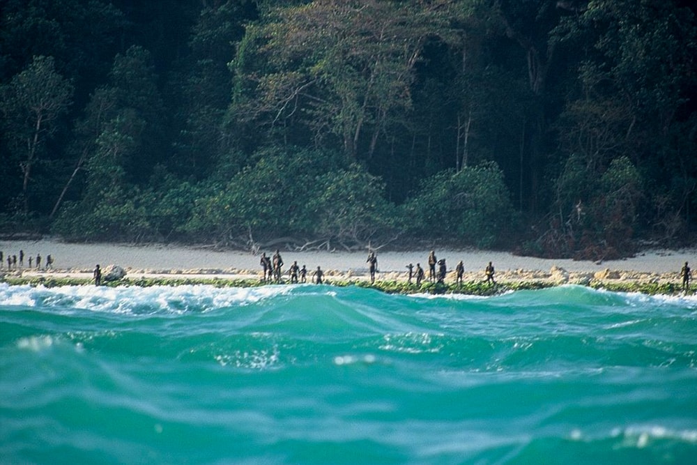 Sentinelis lined up on the shore of North Sentinel Island, ready to fight off visitors