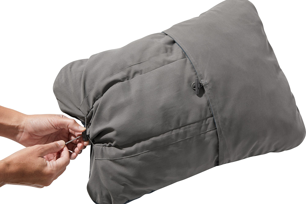 a hand holds the travel pillow