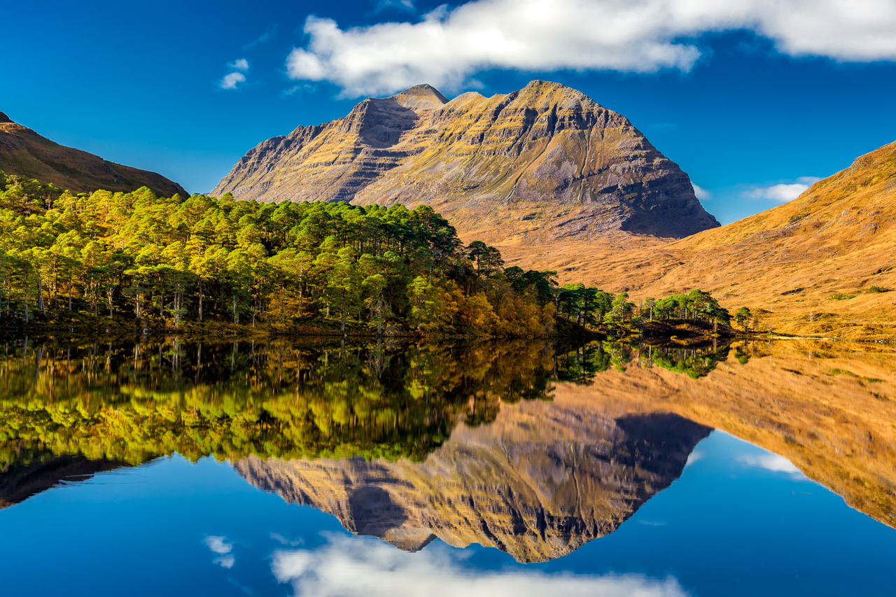 Liathach and reflection of it in Loch Clair on a sunny autumn day