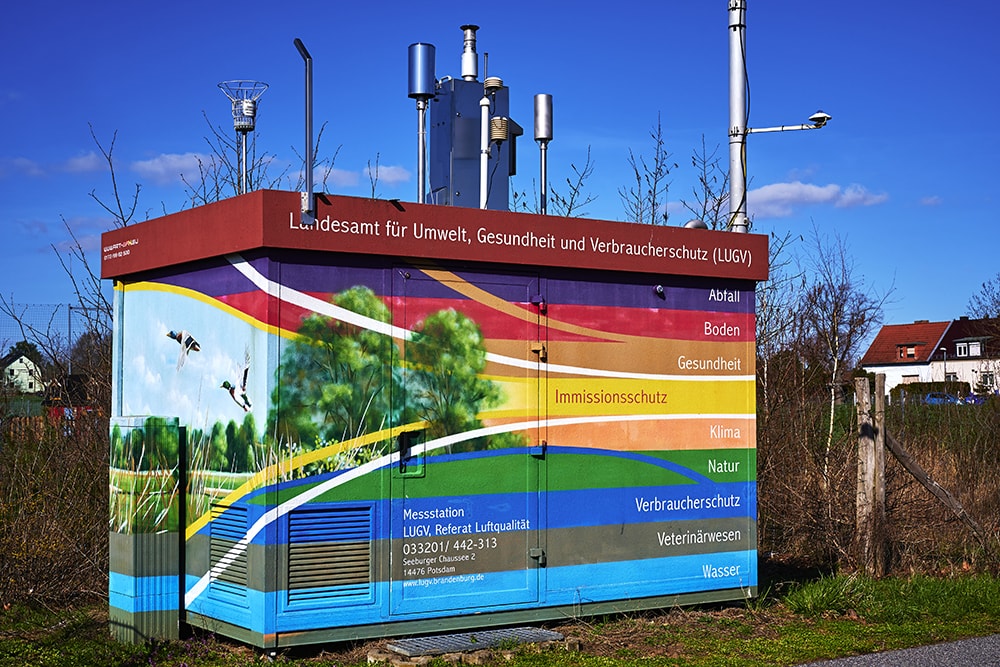 A colourful porta cabin with equipment on the roof