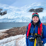 Peter in front of a gentoo penguin colony in Antarctica