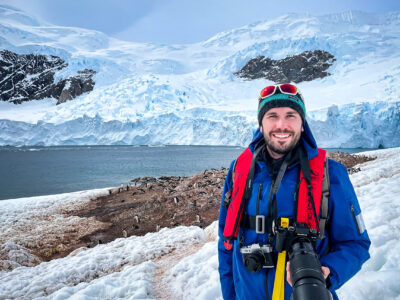 Peter in front of a gentoo penguin colony in Antarctica