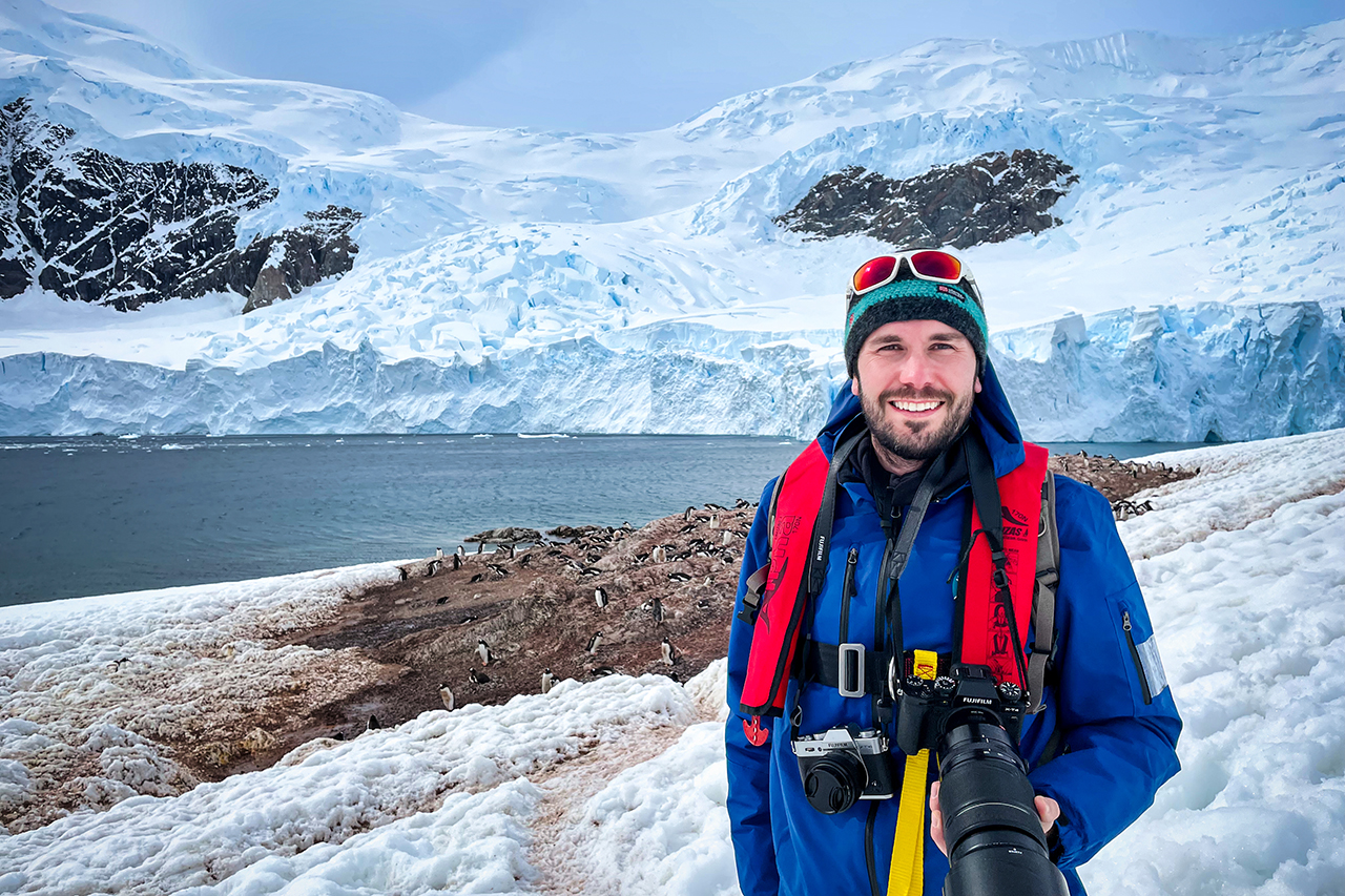 Peter in front of a gentoo penguin colony in Antarctica