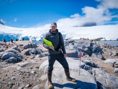 Peter with a clipboard working as the wildlife monitor in Antarctica